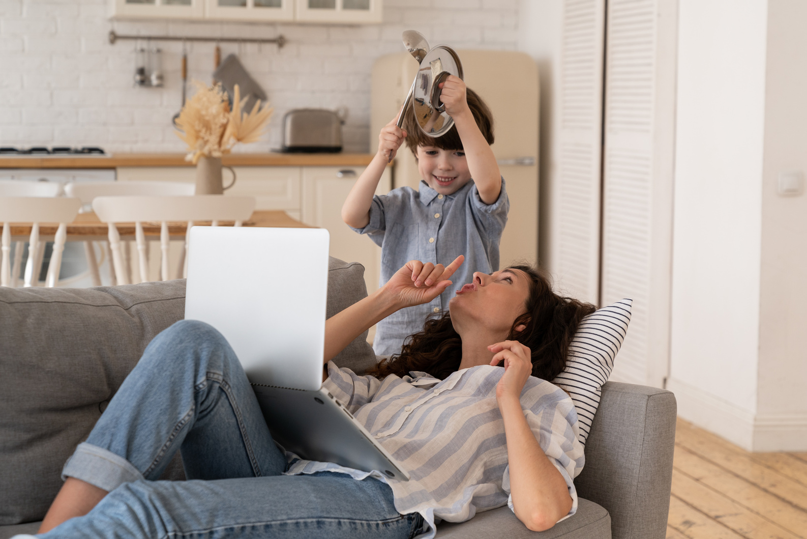 Stressed Mother Working from Home with Son